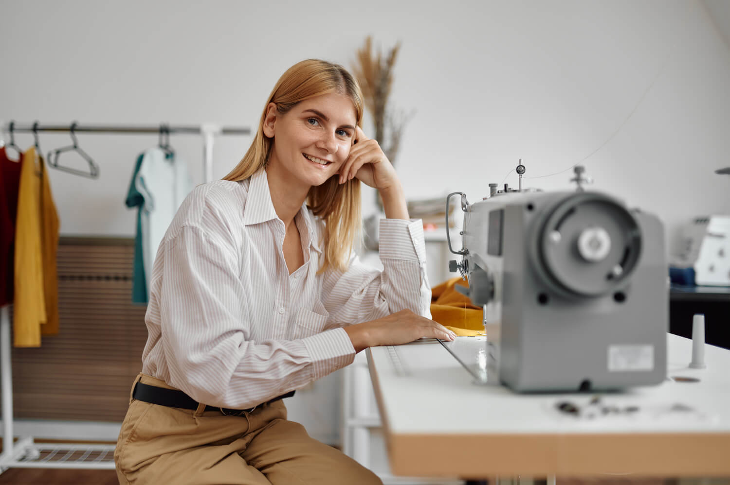 seamstress-works-on-sewing-machine-at-workplace-5A8NBHL.jpg