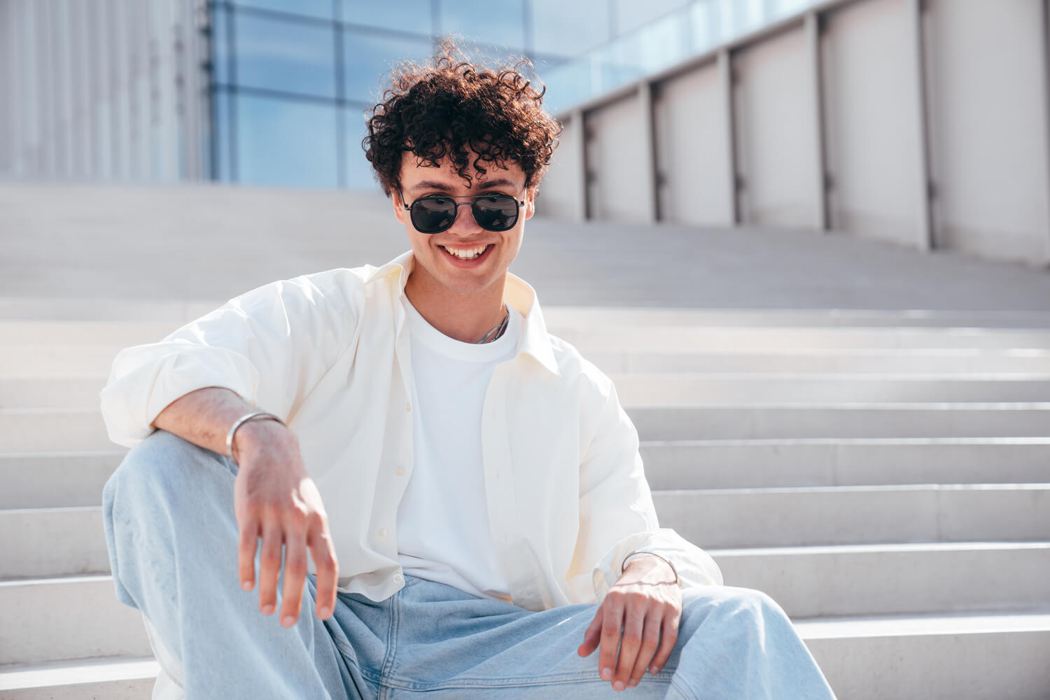young-attractive-man-sits-at-stairs-9DH3EPJ.jpg