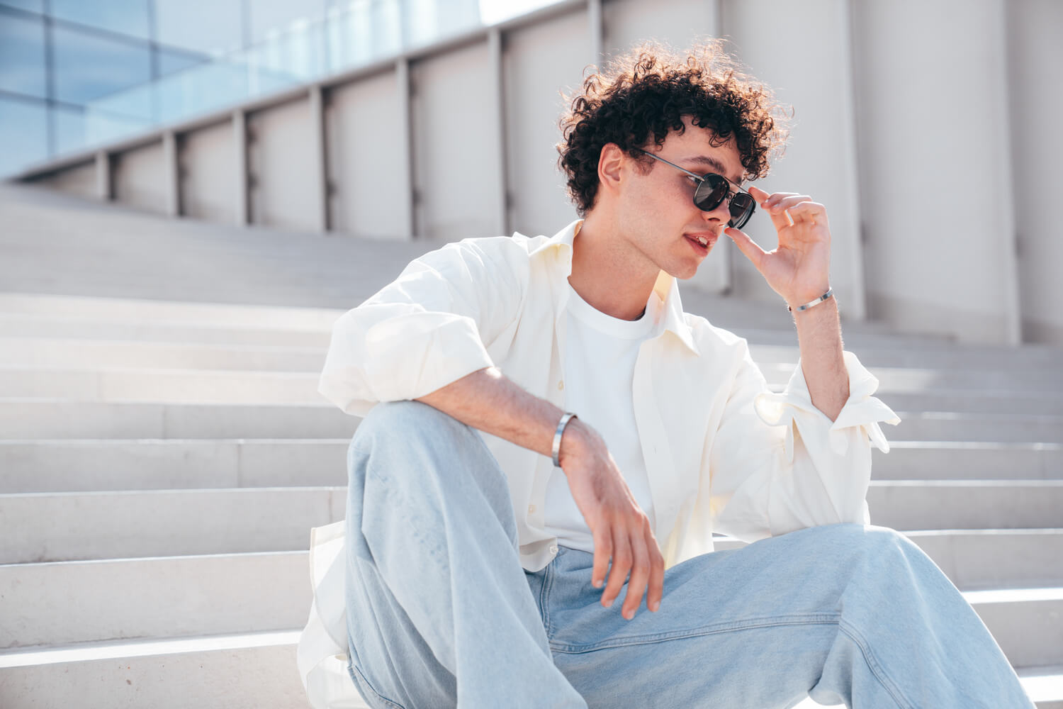 young-attractive-man-sits-at-stairs-DUXH6L2.jpg