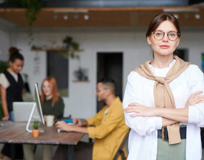 Confident businesswoman in a modern office space, embodying success and leadership.