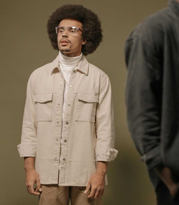 Three stylish men in contemporary fashion posing in a studio setting. Neutral tones and modern style.